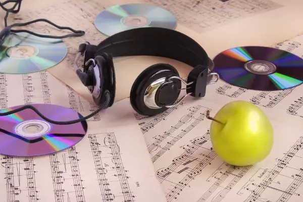 Depositphotos_21726841_S Headphones, CDs, sheet music and apple