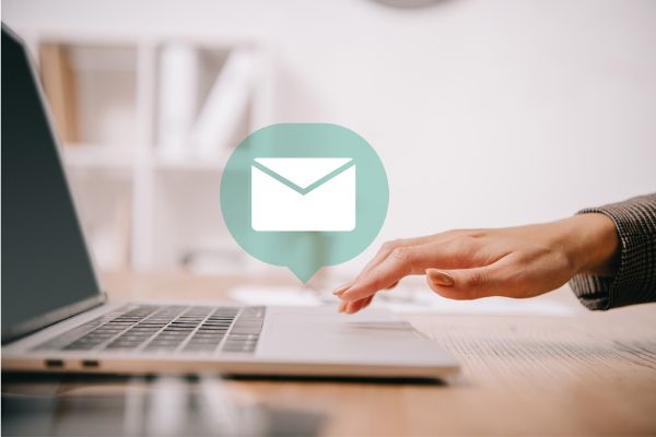 Depositphotos_231857118_S Cropped view of businesswoman typing on laptop at workplace with email icon