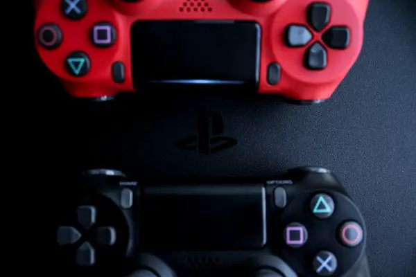 Depositphotos_302397562_S PS4 console background. Playstation 4 controllers. Sony gaming console