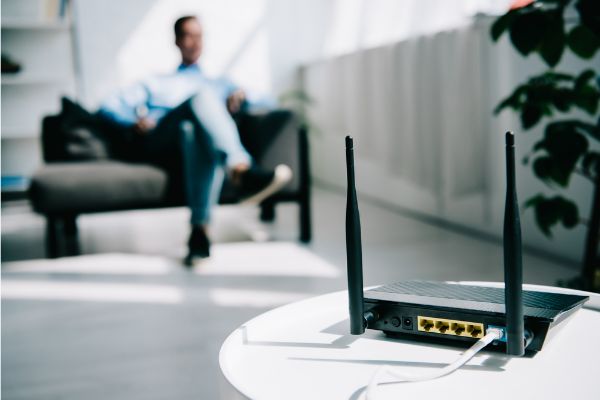 Depositphotos_310724444_S Selective focus of black plugged router on white table