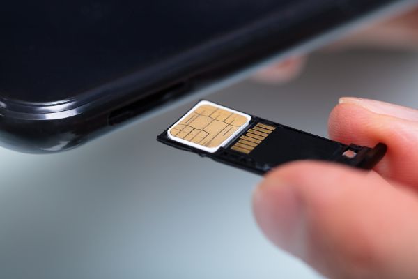 Depositphotos_336768828_S Close up Of A Person's Hand Inserting Sim Card