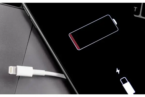 Depositphotos_363256698_S Apple iPhone smartphone with Lightning cable low battery