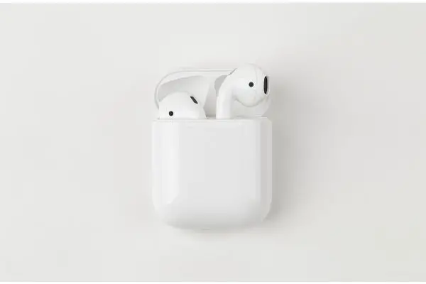 Depositphotos_372394532_S Apple AirPods on a white background. Wireless headphones in a charging case close-up.