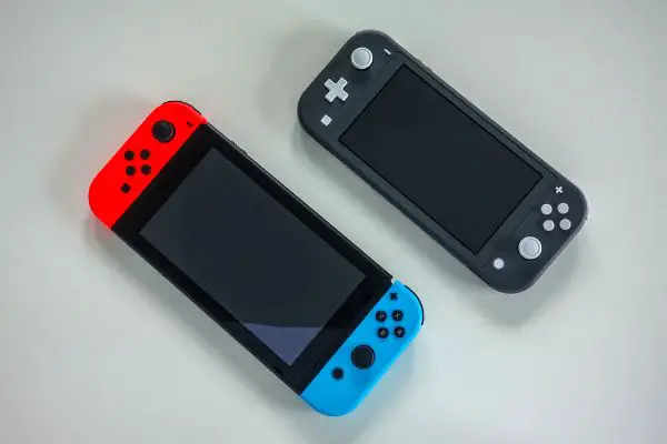 Depositphotos_377434260_S A multiplayer Nintendo Switch and single player Nintendo Switch Lite gaming consoles side by side.