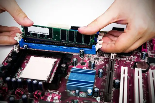 Depositphotos_37966645_S Man installing memory. PC motherboard RAM upgrade