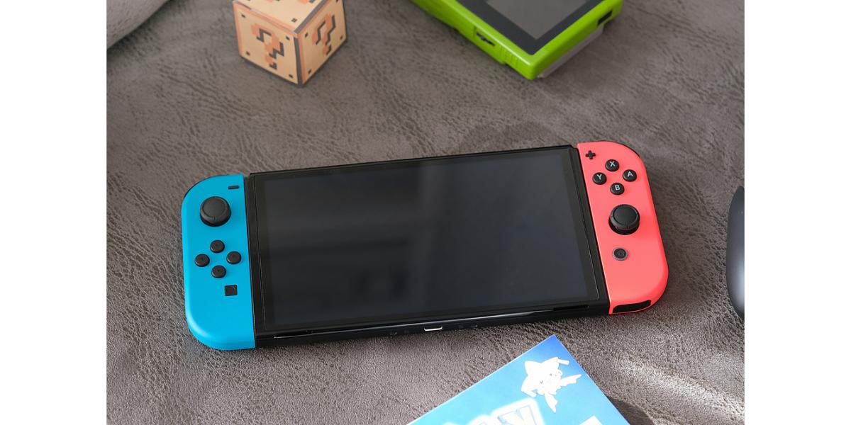 Depositphotos_658232494_S Nintendo Switch video game console in a home living room near nintendo related items