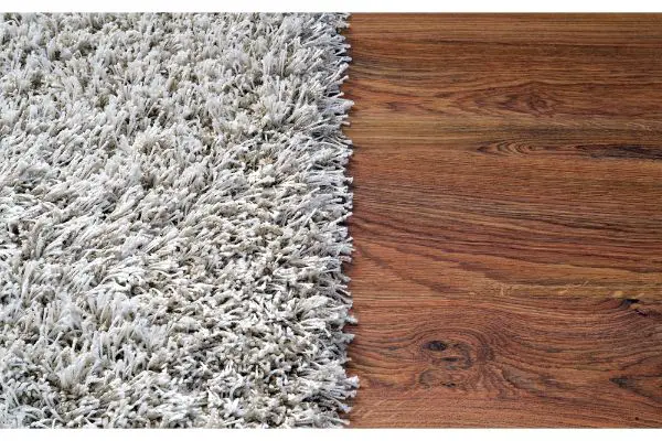 Depositphotos_67261117_S Two part split image of white shaggy carpet and hard wood floor