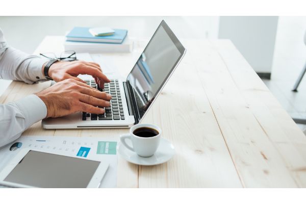 person using laptop working at desk