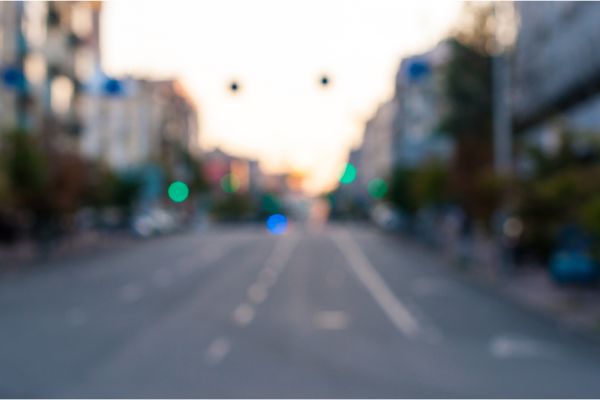 Depositphotos_78965440_S Blured empty evening street at the city. Urban background