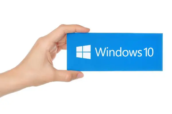 Depositphotos_85345286_S Hand holds Windows 10 logotype printed on paper
