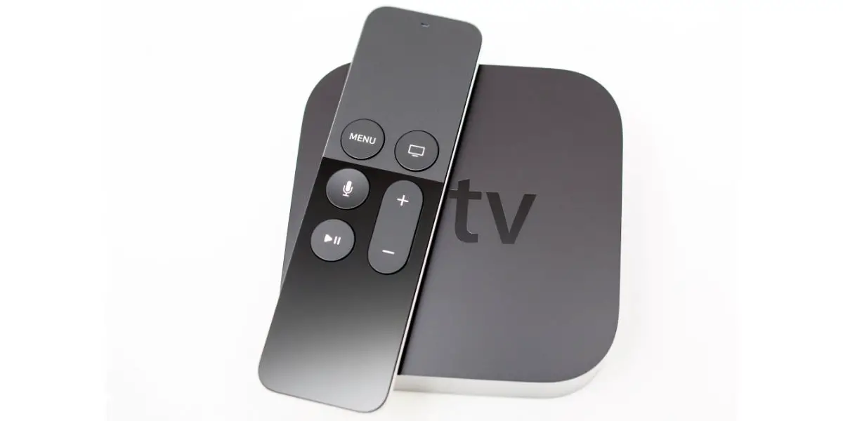 Depositphotos_98205654_L Siri remote over New Apple TV console on white background