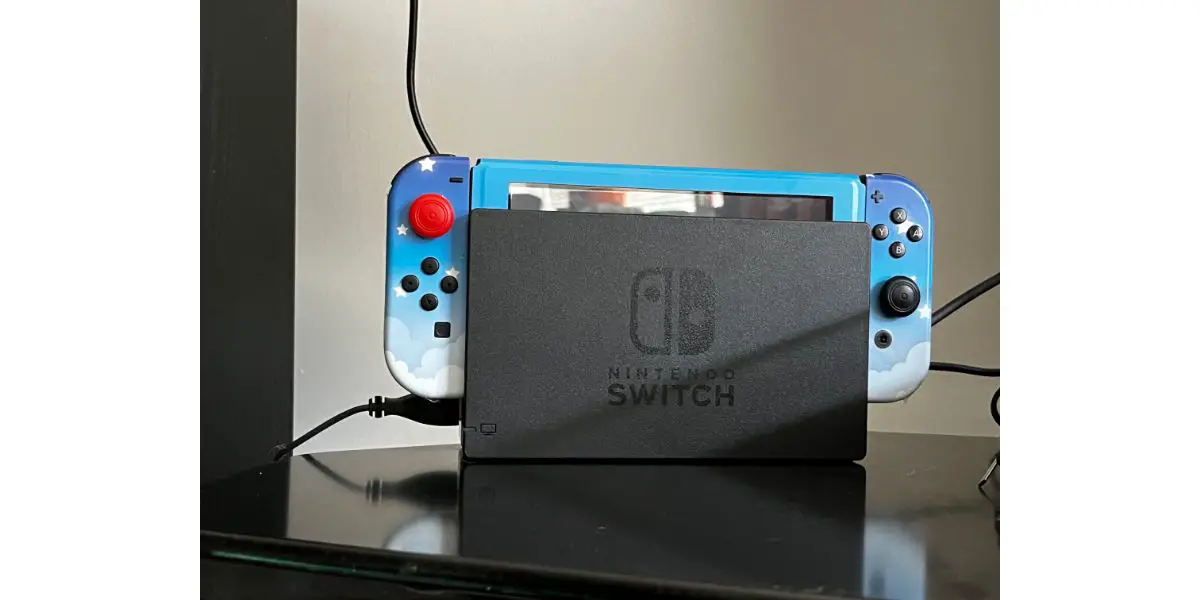 Nintendo switch with sky skin in dock connected to tv